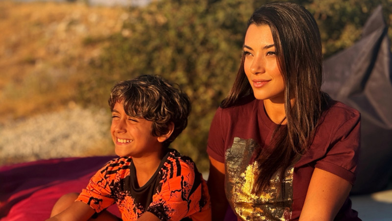 Marianne and son sit facing sun