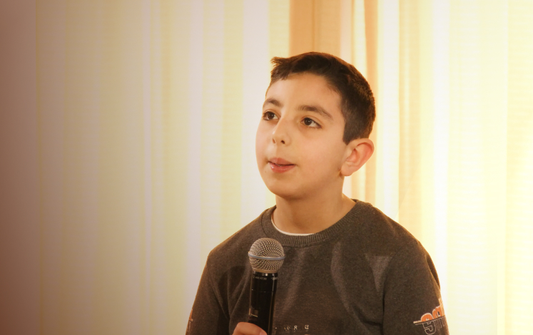 Boy speaking into microphone