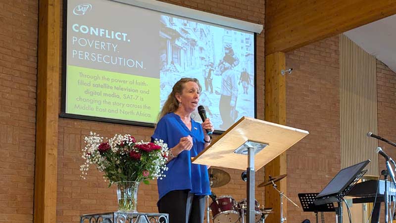 Woman speaking at front of church