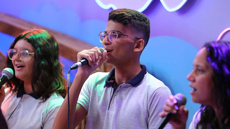 Three young people singing