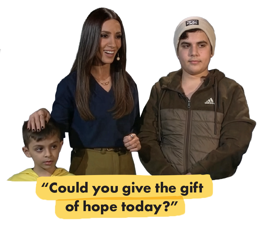 Woman and two children standing. Woman places hand on one childs head. Text below reads "Could you give the gift of hope today?"