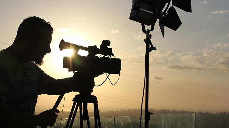Man with camera silhouetted against Beirut sky