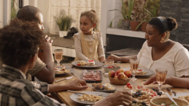 People sitting around a table eating and talking